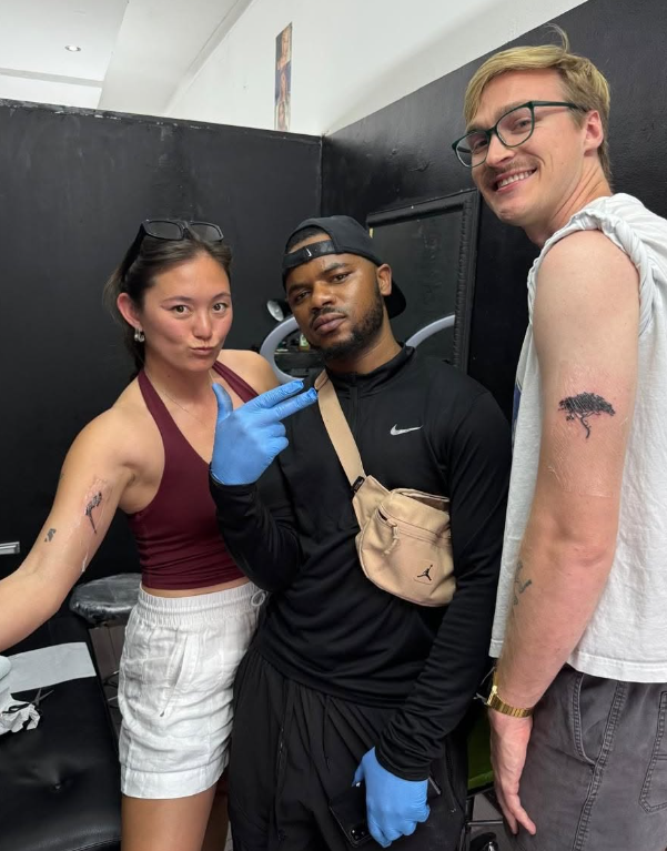 Bloodwell with two happy clients showing fresh tattoos